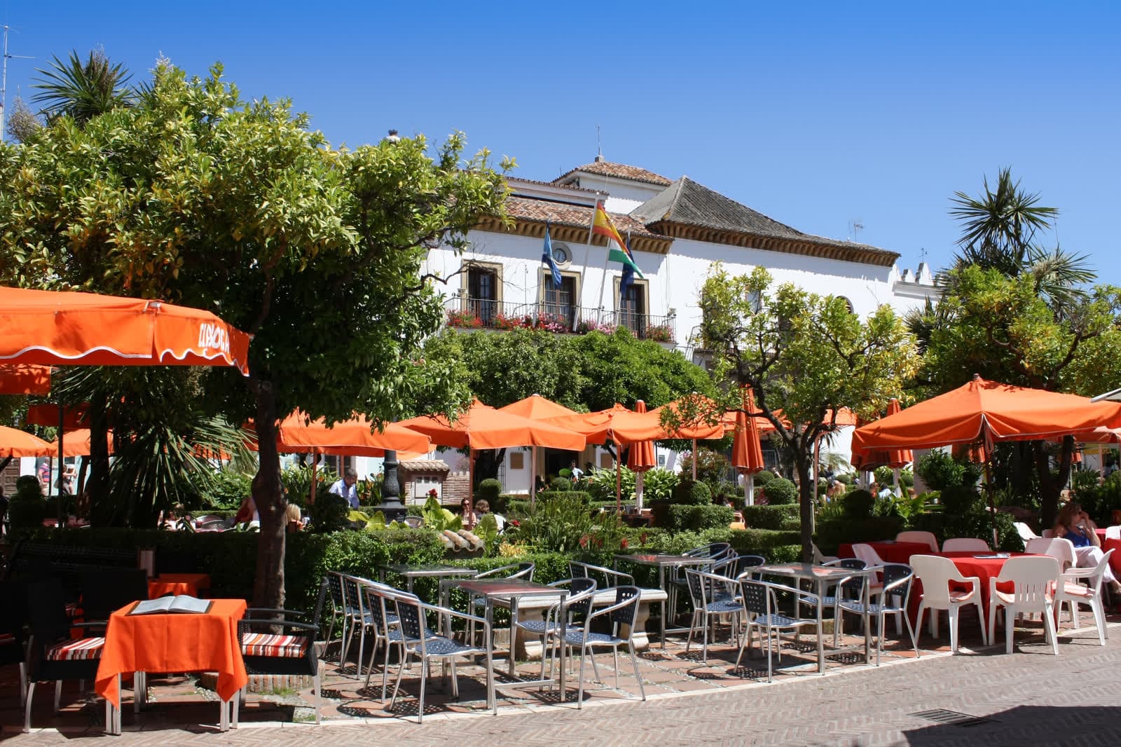 Plaza de los Naranjos in Marbella old town, with orange trees, cafe umbrellas and the town hall
